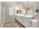 Bright bathroom featuring double sinks, spacious counter tops, and a glass enclosed shower at 40141 W James Ln, Maricopa, AZ 85138