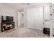 A bedroom with a television and closet with sliding doors at 40141 W James Ln, Maricopa, AZ 85138