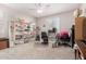 A bedroom with a desk and two chairs by the window at 40141 W James Ln, Maricopa, AZ 85138