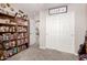 Bedroom with large closet with sliding doors and built-in bookcase along the wall at 40141 W James Ln, Maricopa, AZ 85138