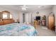 Bedroom features a ceiling fan, TV, and a dresser for additional storage space at 40141 W James Ln, Maricopa, AZ 85138