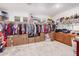 Large walk-in closet with hanging clothes and storage boxes offers plenty of space at 40141 W James Ln, Maricopa, AZ 85138