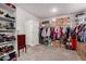 Spacious walk-in closet with storage boxes and shelving ensures maximum storage capacity at 40141 W James Ln, Maricopa, AZ 85138