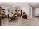 Bright dining area with wood-look tile flooring, a ceiling fan, and ample space for entertaining at 40141 W James Ln, Maricopa, AZ 85138