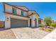 Charming two-story home featuring a two-car garage, a cozy porch, and desert landscaping at 40141 W James Ln, Maricopa, AZ 85138