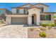 Charming two-story home featuring a two-car garage, a cozy porch, and desert landscaping at 40141 W James Ln, Maricopa, AZ 85138