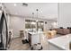 Bright kitchen features a center island, stainless steel appliances, and sliding glass doors to the backyard at 40141 W James Ln, Maricopa, AZ 85138