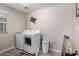 Functional laundry room with washer, dryer, and storage at 40141 W James Ln, Maricopa, AZ 85138