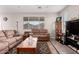 Inviting living room with neutral walls, tile floors, and comfortable seating arrangements at 40141 W James Ln, Maricopa, AZ 85138