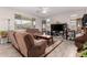 Cozy living room featuring tile floors, neutral paint, a ceiling fan, and comfortable seating at 40141 W James Ln, Maricopa, AZ 85138