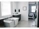 Bright bathroom featuring a freestanding tub, elegant fixtures, and views into the bedroom at 4040 E Caitlin Dr, San Tan Valley, AZ 85140