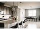 Open-concept kitchen with barstool seating connects to a dining area filled with natural light at 4040 E Caitlin Dr, San Tan Valley, AZ 85140