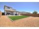 Expansive backyard featuring artificial grass, gravel accents, and a patio area, ideal for entertaining at 40927 W Sunland Dr, Maricopa, AZ 85138
