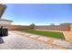 Beautiful backyard with artificial grass, a paver patio, and gravel landscaping for low maintenance at 40927 W Sunland Dr, Maricopa, AZ 85138
