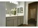 Bathroom featuring a double sink vanity with cabinet storage and modern fixtures at 40927 W Sunland Dr, Maricopa, AZ 85138