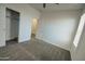 Bedroom features neutral paint, a ceiling fan, and closet with sliding doors at 40927 W Sunland Dr, Maricopa, AZ 85138