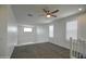 Bright bonus room features neutral carpeting, white railing and plantation shutters at 40927 W Sunland Dr, Maricopa, AZ 85138