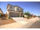 This exterior showcases a two-story home with a stone facade and a two-car garage at 40927 W Sunland Dr, Maricopa, AZ 85138