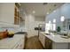 Well-equipped kitchen featuring white cabinetry, a stainless steel gas range, quartz countertops, and an island with a sink at 40927 W Sunland Dr, Maricopa, AZ 85138