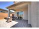 Covered patio featuring comfortable wicker seating and a neutral rug, creating an inviting outdoor space at 40927 W Sunland Dr, Maricopa, AZ 85138