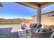 Inviting covered patio featuring cozy seating and a patterned rug, perfect for outdoor relaxation at 40927 W Sunland Dr, Maricopa, AZ 85138