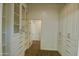 Spacious walk-in closet featuring custom built-in shelving and ample storage space at 40927 W Sunland Dr, Maricopa, AZ 85138
