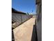 Fenced backyard featuring a concrete walkway and potential for landscaping and outdoor living at 4154 W Morten Ave, Phoenix, AZ 85051