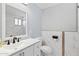 Bathroom with vanity, toilet, and elegant white marble tiled walls at 4154 W Morten Ave, Phoenix, AZ 85051