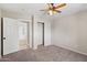 Neutral bedroom featuring a ceiling fan, closet with sliding doors, and adjacent space at 4154 W Morten Ave, Phoenix, AZ 85051