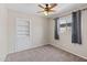 Neutral bedroom featuring a ceiling fan, window with blinds, and built in shelving at 4154 W Morten Ave, Phoenix, AZ 85051