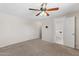 Bedroom with carpet, ceiling fan, and bathroom access at 4154 W Morten Ave, Phoenix, AZ 85051