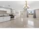 Bright, open kitchen seamlessly connects to a living area, offering ample counter space and modern stainless steel appliances at 4154 W Morten Ave, Phoenix, AZ 85051