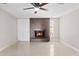 Living room with tile flooring, fireplace with tile surround, and ceiling fan at 4154 W Morten Ave, Phoenix, AZ 85051