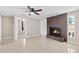 The fireplace adds warmth to a room with modern flooring, ceiling fan and light, offering a blend of comfort and style at 4154 W Morten Ave, Phoenix, AZ 85051