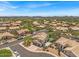 Aerial view of a neighborhood featuring desert landscaping, community roads, and mountain views at 4402 E Barwick Dr, Cave Creek, AZ 85331
