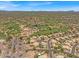 Expansive aerial view of a desert community featuring a golf course, lush landscaping, and stunning mountain views at 4402 E Barwick Dr, Cave Creek, AZ 85331