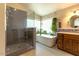 A bathroom featuring a shower, tub, and windows that allow plenty of natural lighting at 4402 E Barwick Dr, Cave Creek, AZ 85331