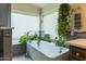 Bathroom featuring a free-standing tub with plants and windows that provide lots of natural light at 4402 E Barwick Dr, Cave Creek, AZ 85331