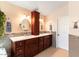 A bathroom with double sinks, a vanity, a mosaic tiled backsplash, and a bull painting at 4402 E Barwick Dr, Cave Creek, AZ 85331