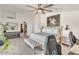 A bedroom with white walls, carpet floors, a ceiling fan, a horse painting, and a view of the bathroom at 4402 E Barwick Dr, Cave Creek, AZ 85331