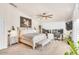 A bedroom with white walls, carpet floors, a ceiling fan, a horse painting, a bed, and a desk at 4402 E Barwick Dr, Cave Creek, AZ 85331