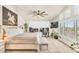 A bedroom with white walls, carpet floors, a ceiling fan, a horse painting, a bed, and a desk at 4402 E Barwick Dr, Cave Creek, AZ 85331
