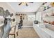 A bedroom with white walls, carpet floors, ceiling fan, a workspace, and shelving along the walls at 4402 E Barwick Dr, Cave Creek, AZ 85331