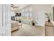 A bedroom with white walls, carpet floors, three windows with shutters, plants, and a TV at 4402 E Barwick Dr, Cave Creek, AZ 85331