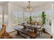 Dining room with modern light fixture and plantation shutters overlooking lush yard at 4402 E Barwick Dr, Cave Creek, AZ 85331