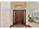 Beautiful entryway with a wood door, sidelights, and a glimpse into the bright living room at 4402 E Barwick Dr, Cave Creek, AZ 85331