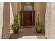 Inviting entryway features a solid wood door with decorative sidelights and tiled flooring at 4402 E Barwick Dr, Cave Creek, AZ 85331