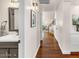 Hallway with hardwood flooring leading to a bathroom, staircase, and additional living spaces at 4402 E Barwick Dr, Cave Creek, AZ 85331
