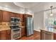 Updated kitchen features stainless steel appliances, wooden cabinets, granite counters and tile backsplash at 4402 E Barwick Dr, Cave Creek, AZ 85331