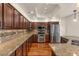 Kitchen featuring expansive granite countertops, custom cabinets, and stainless-steel appliances at 4402 E Barwick Dr, Cave Creek, AZ 85331